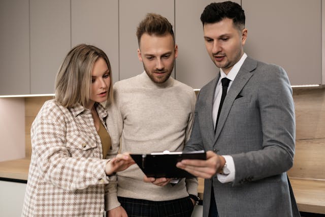 A set of tenants looking over a contract with a property manager