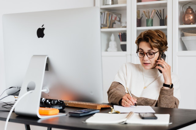 a person on the phone at their desk