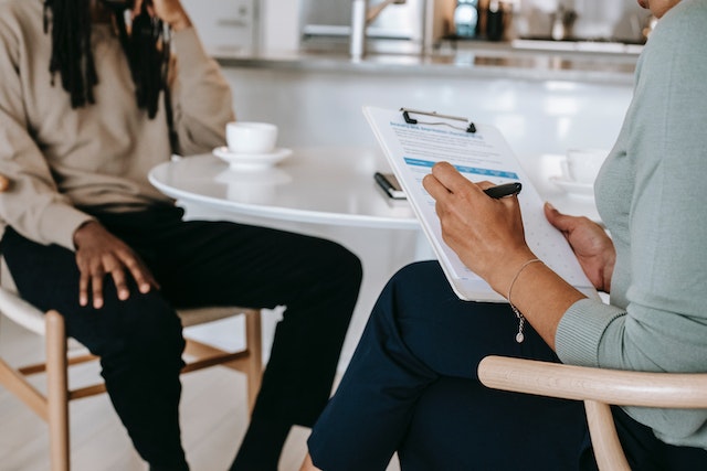 landlord conducting a tenant screening and reading off a checklist